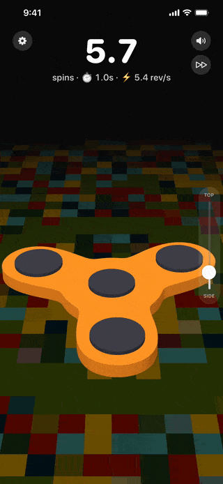 A fidget spinner turning flat on a lit disco floor of colored tiles.